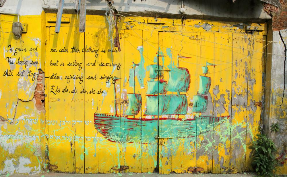 RED CROWN GREEN PARROT In red and green color their clothing is made. The long sea boat is singing and searching . All sit together, rejoicing and singing. Ela, elo, ela, elo, ela, elo.