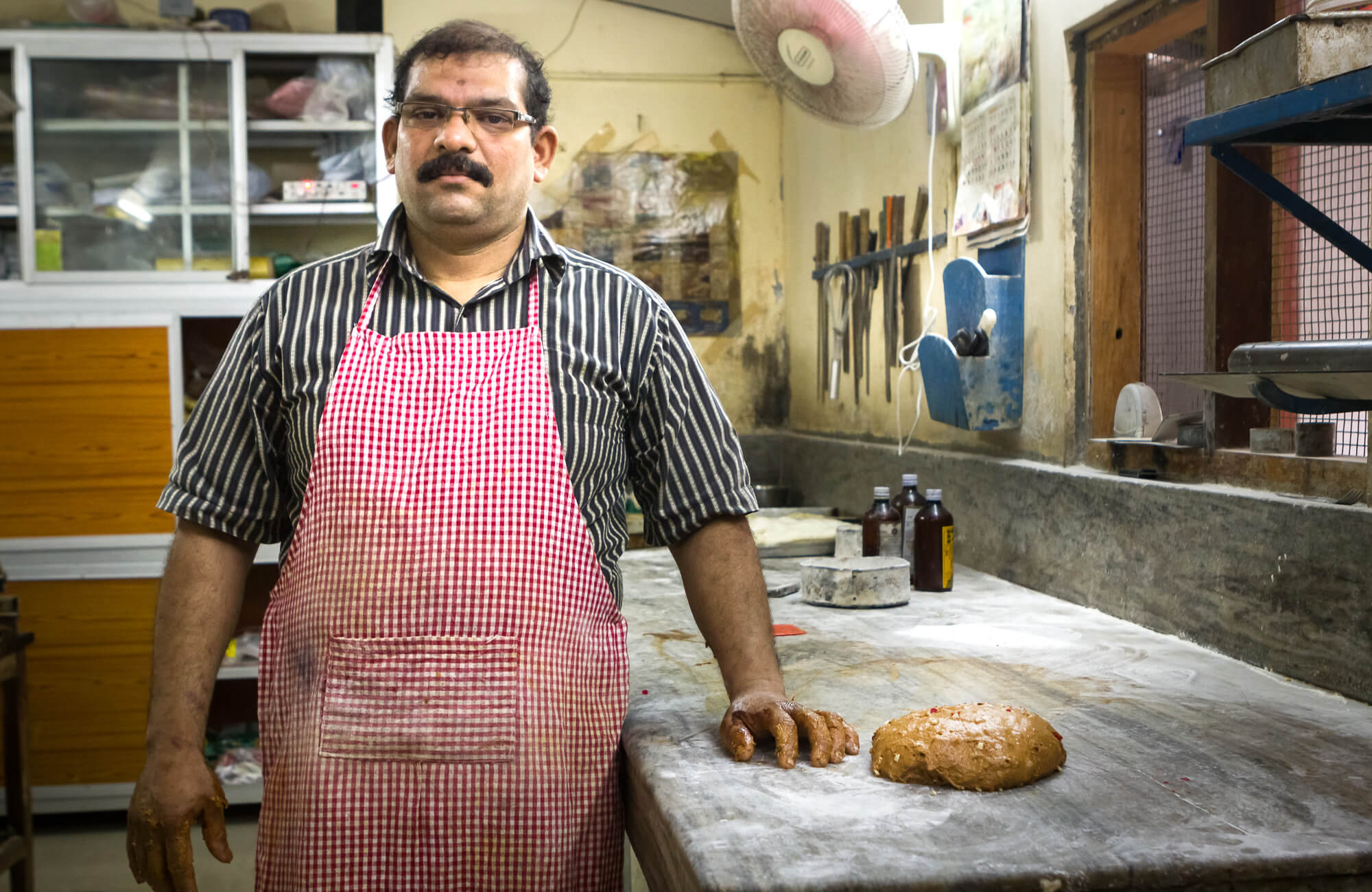 BREUDHER - THE STORY OF A DUTCH BREAD  -  Asheeq, the chef at Elite Hotel posing for a photograph after mixing the breudher dough. 