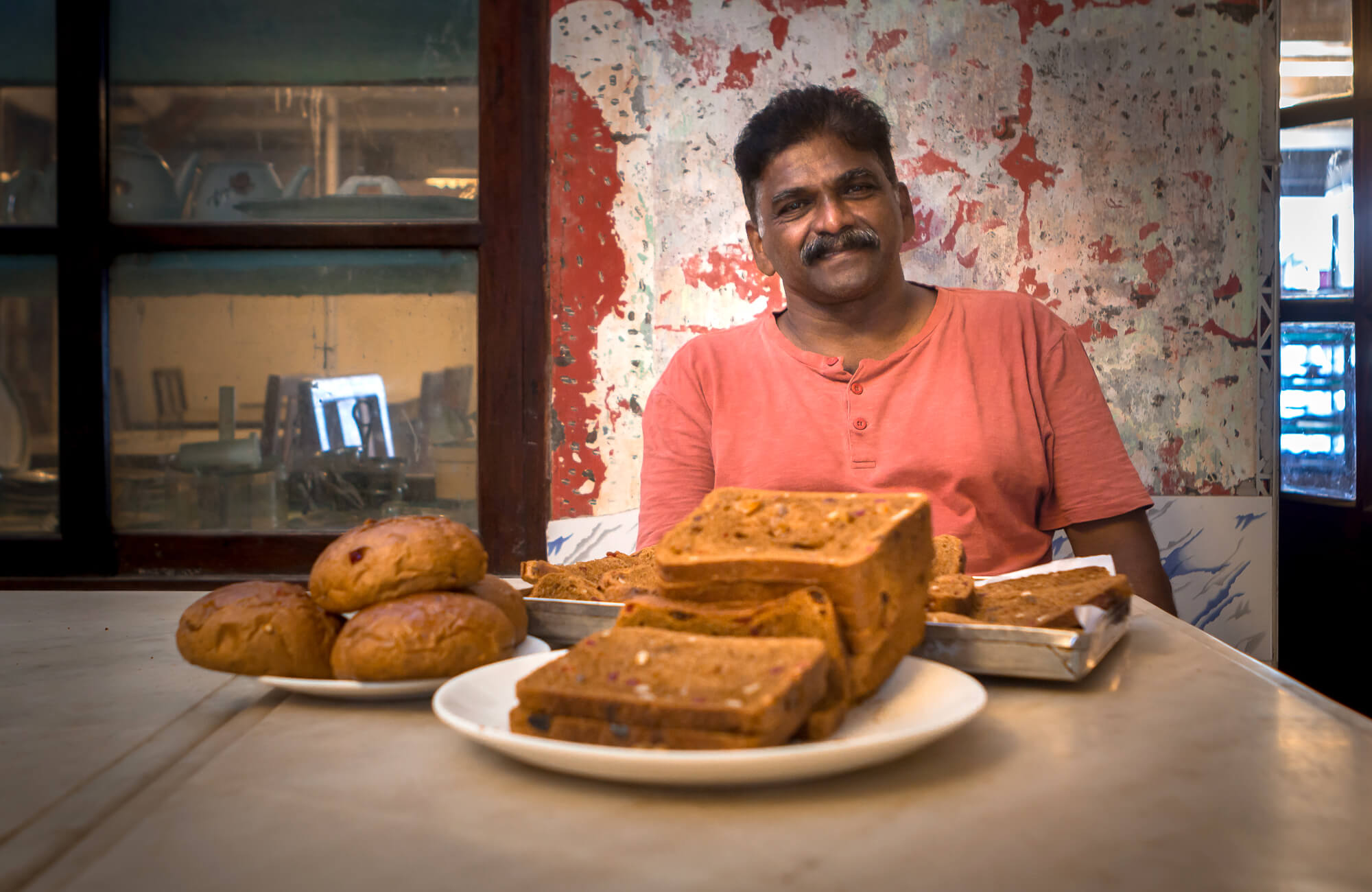 BREUDHER - THE STORY OF A DUTCH BREAD  -  James, the current owner of Elite Hotel seen with breudher made at their bakery.